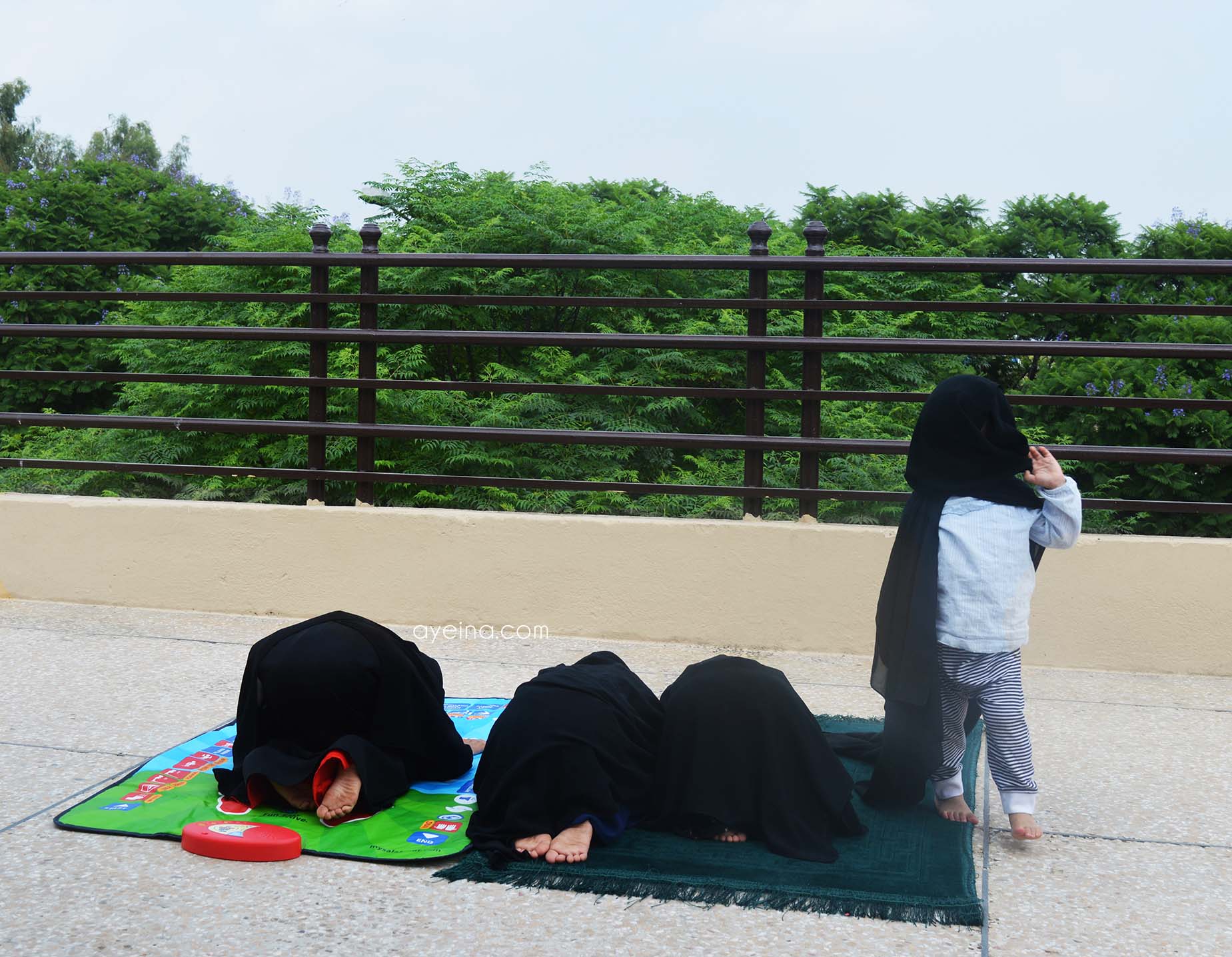 my salah mat kids on rooftop greenery trees pray together stay muslimah hijab